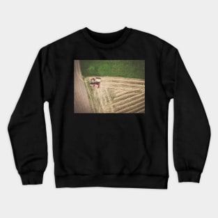 Aerial view of combine-harvester and tractor working in the field Crewneck Sweatshirt